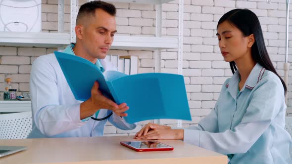 Doctor in Professional Uniform Examining Patient at Hospital