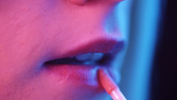 Beautiful Female Female Lips Closeup in Colored Lighting