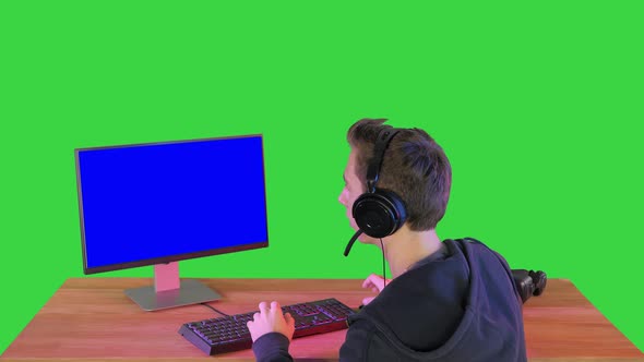 Excited Gamer with Headphones Smiling To the Camera on a Green Screen, Chroma Key