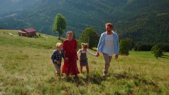 Family Stepping Green Grass on Walk to Top Green Slope