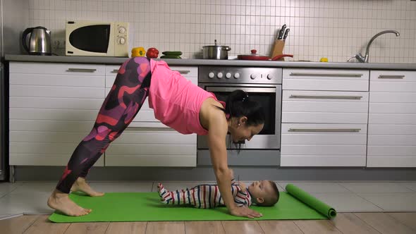 Fit Female Doing Yoga Together with Baby at Home