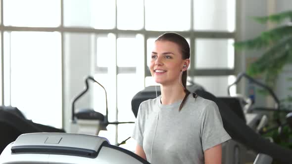 Smiling Girl Running on a Treadmill.