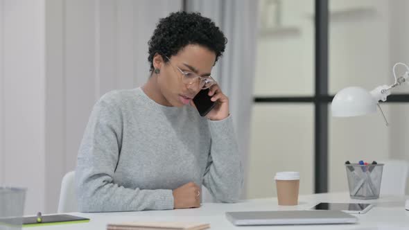 Angry African Woman Talking on Smartphone