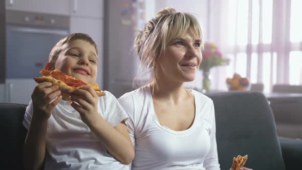 Family Laughing Eating Pizza and Watching Cartoon