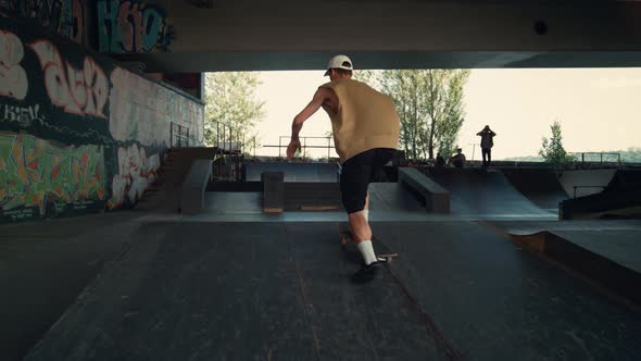 Young Skater Riding on Skateboard at City Skatepark