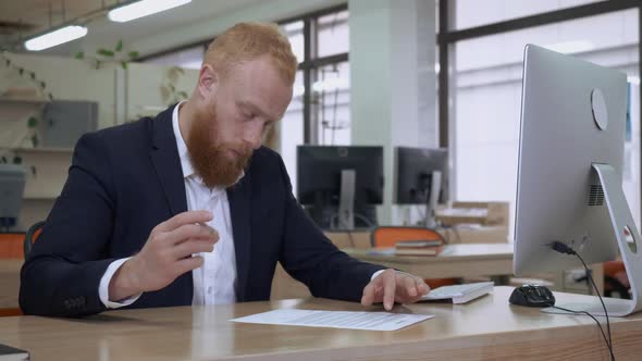 Manager Reading Document and Writing Signature