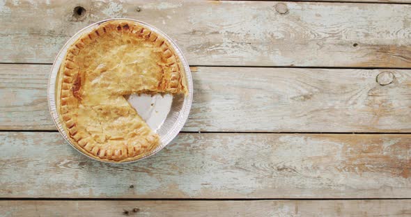 Video of pie seen from above on wooden background