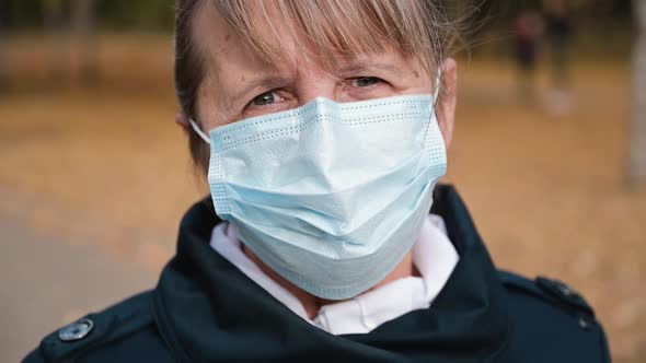 Portrait of a Senior Woman in a Respirator Protection Mask