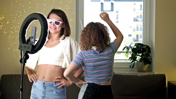 Cheerful Young Woman and Her Teenage Daughter are Actively Dancing Moving Emotionally Having Fun in