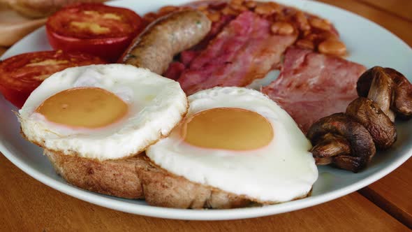 English Breakfast Close Up Fried Eggs Sausages Bacon Tomatoes Tomato Beans Toasts in White Plate on