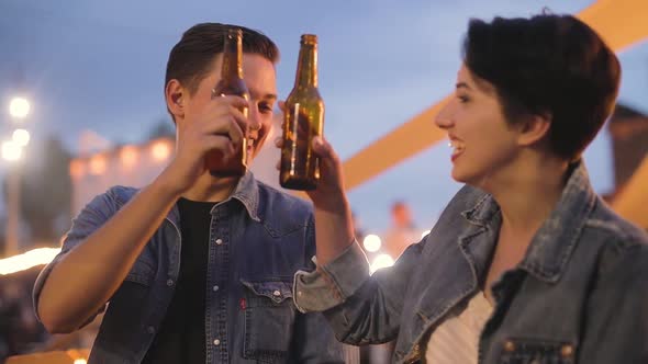 Couple At Party, Drinking Beer And Communicating Outdoors