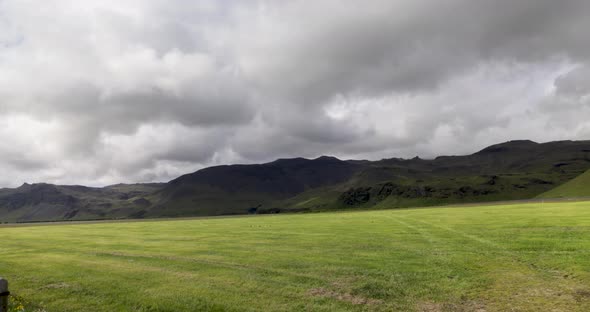 Mountains in Iceland and field with video panning left to right.