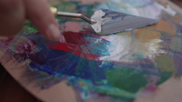 Closeup Painting Knife Mixing Colors on Artist Palette in Slow Motion