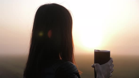 Woman Traveler Hands Holding Cup of Tea or Coffee. Wonderful Morning Hot Drink on a Journey