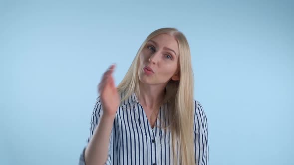 Young Female Showing Gestures "Go Away" on Blue Background