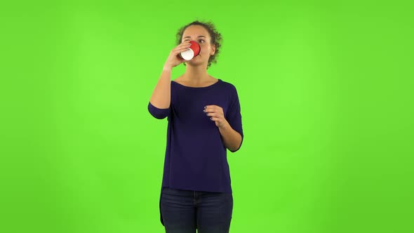 Curly Woman Drinking Unpalatable Coffee and Is Disgusted . Green Screen