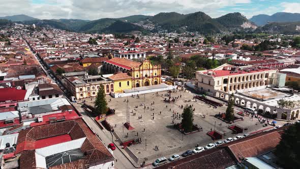 Aerial Close Up and Establishing Shot at San Cristobal de las Casas Cathedral Square - Down Forward