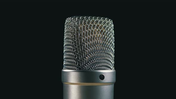 Studio Condenser Microphone Rotates on a Black Background