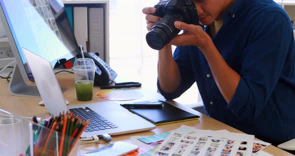 Male executive clicking a picture on digital camera 4k