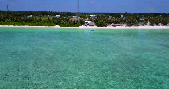 Wide fly over clean view of a sunshine white sandy paradise beach and turquoise sea background