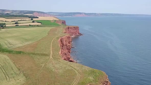 STATIC CROP, Aerial view of redstone cliffs separating land and sea