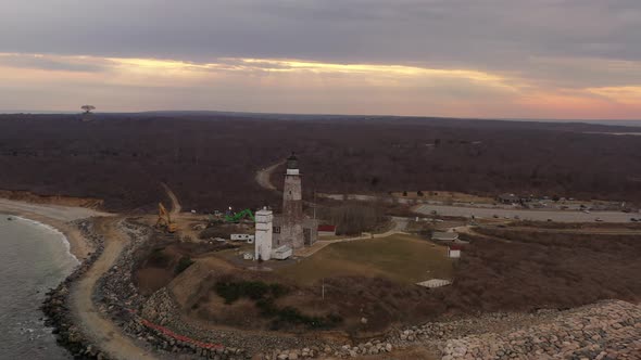 An aerial view of the Montauk lighthouse during a beautiful sunset. The drone camera truck left and