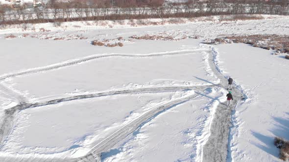 People are skating on frozen lake