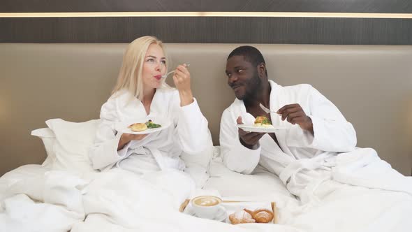 Adorable Multiethnic Couple Have Breakfast in Hotel