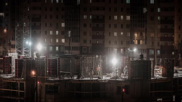 Construction Site Residential Estate Building in City Constructors Working at Winter Night Snowing