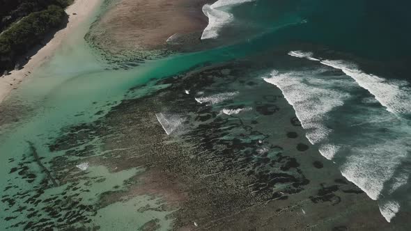 Aerial View of Tropical Beach with Azure Blue Water and Foaming Ocean Waves