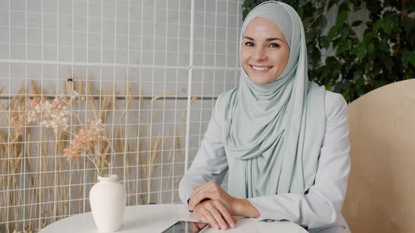 Slow Motion Portrait of Attractive Hijabi Girl Smiling Inside Modern Cafe Enjoying Leisure Time
