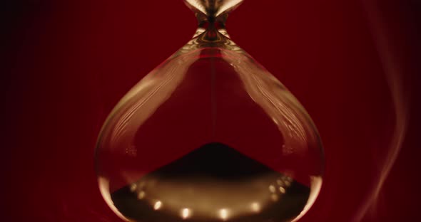 Smoke slowly wrapping an hourglass