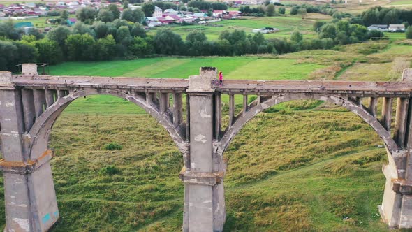 Sportswoman Is Running Along a Desolated Bridge