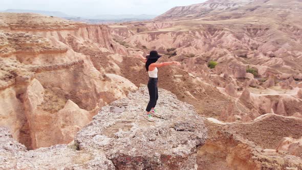 Happy Tourist Dancing On Cliff Over Cappadocia