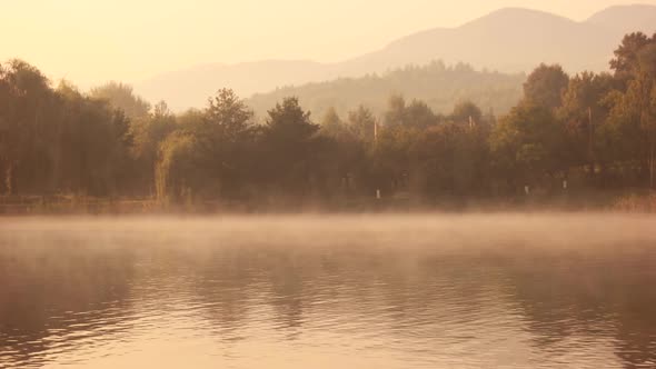 Foggy Morning on a Lake During Sunrise.