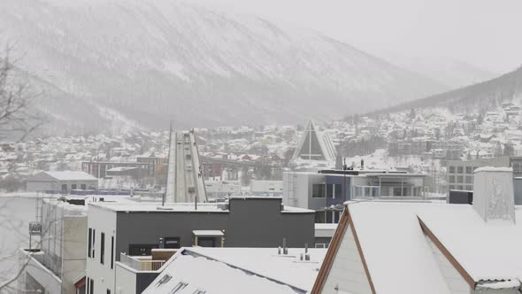 Traffic flow over Tromso Bridge time lapse, city covered in snow; Norway