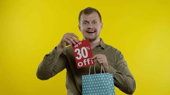 Happy Man Showing Up To 30 Percent Off Inscription From Shopping Bag, Smiling, Rejoicing Discounts