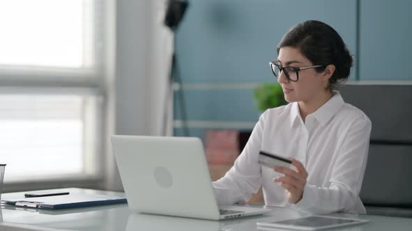 Indian Businesswoman making Successful Online Payment on Laptop