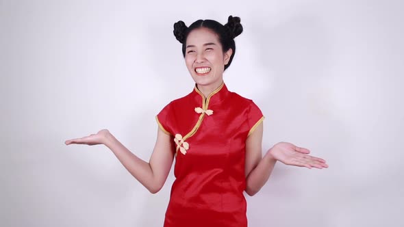 woman wear red cheongsam with open hand palm in concept of happy chinese new year