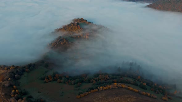 Drone Flight at Sunrise Over Beautiful Autumn Landscape of Mountain Range with Sea of Clouds in