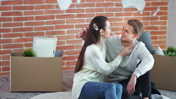 Happy Couple Family Smiling and Hugging Enjoying New Apartment Together Medium Long Shot