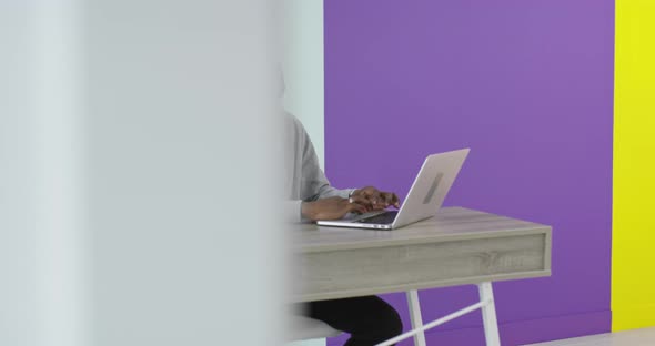 African Businessman Working on Laptop Sitting at Home Office Desk