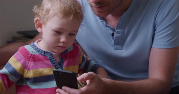 Close up view of caucasian man with baby at home