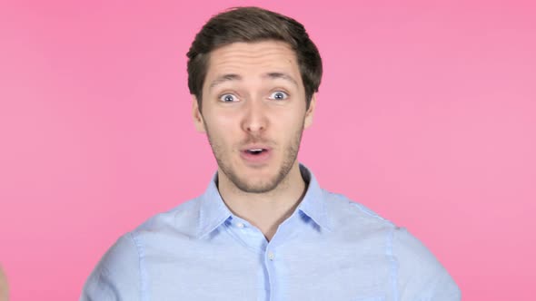 Online Video Chat by Young Man on Pink Background