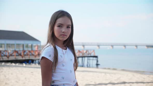 Portrait of Adorable Little Girl at Beach During Summer Vacation