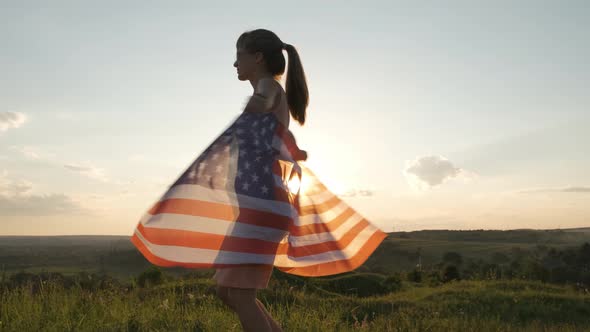 Young Woman Posing with USA National Flag Outdoors at Sunset