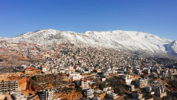 Hermon mountain ridge covered with snow during 2022 winter, with the town houses of Majd al Shams.