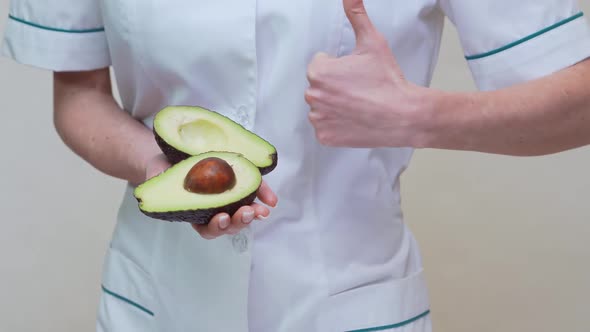 Nutritionist Doctor Healthy Lifestyle Concept - Holding Organic Avocado