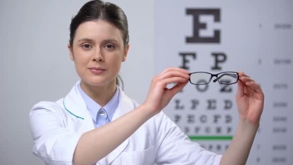 Smiling Female Ophthalmologist Recommending Eyeglasses, Eyesight Correction