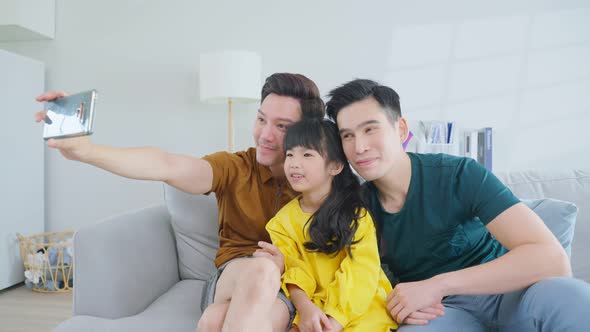 Asian attractive LGBTQ gay family spend time with girl kid daughter.